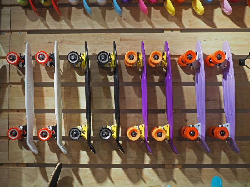 Many surfskate hanging on the skateboard shop wall