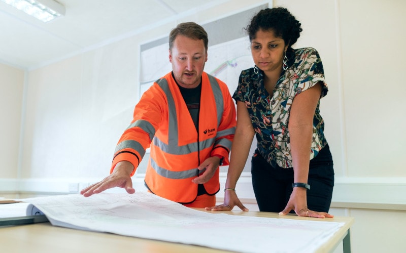 man and woman going over construction plans