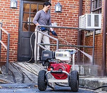 man using Simpson pressure washer
