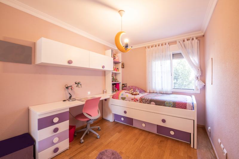 room for teenagers with a trundle bed and pink