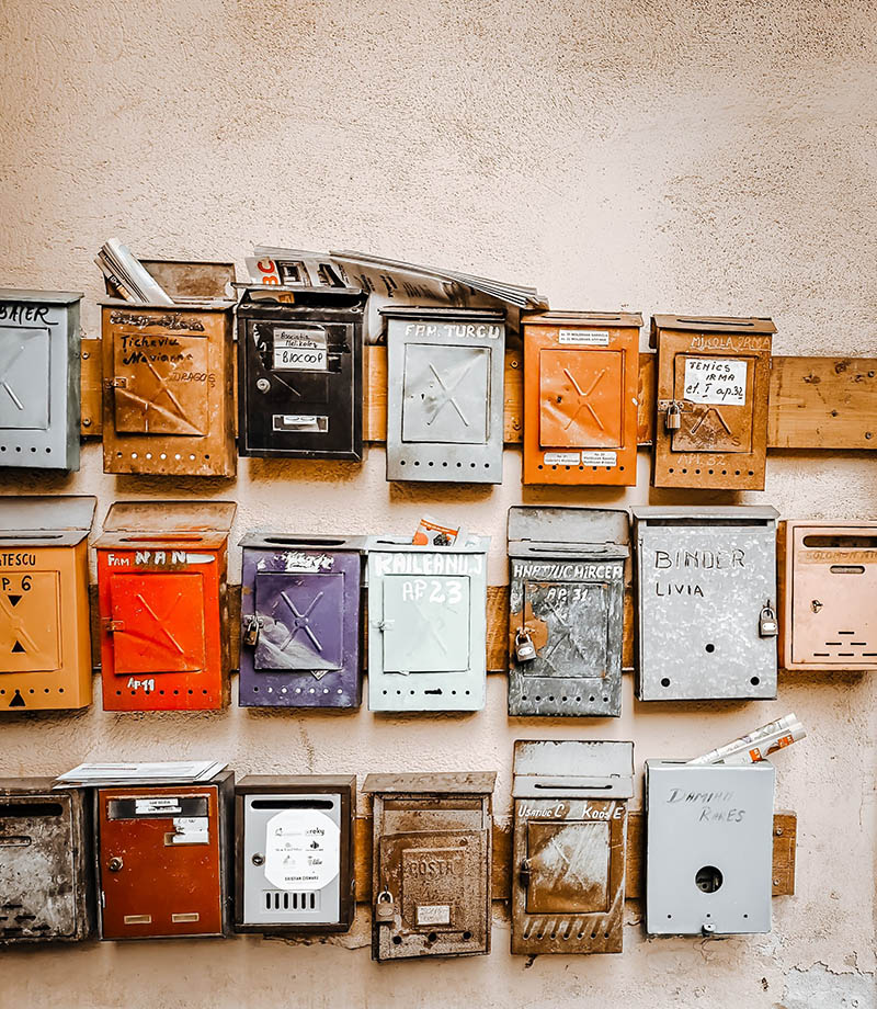 rows of mailboxes mounted on the wall
