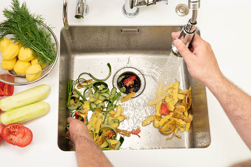 Food waste after peeling vegetables is destroyed using the Disposer