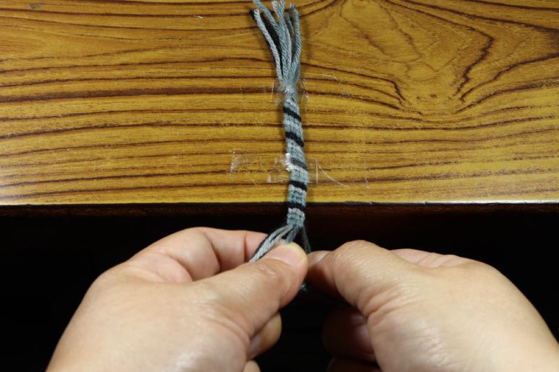 Handmade yarn bracelet knitting with a tape