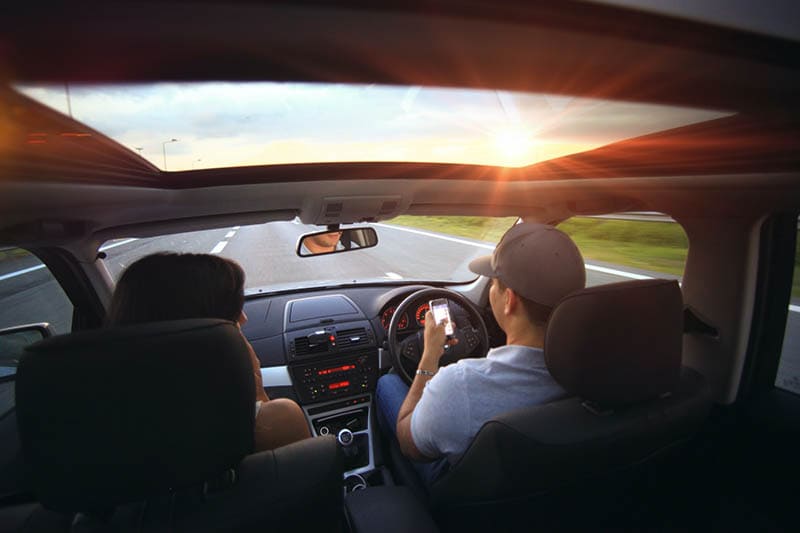 Man Using Smartphone While Driving