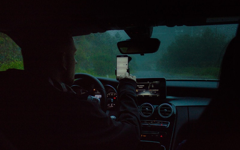 a person using their phone while driving a car