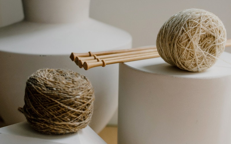 balls of jute twine on white vases