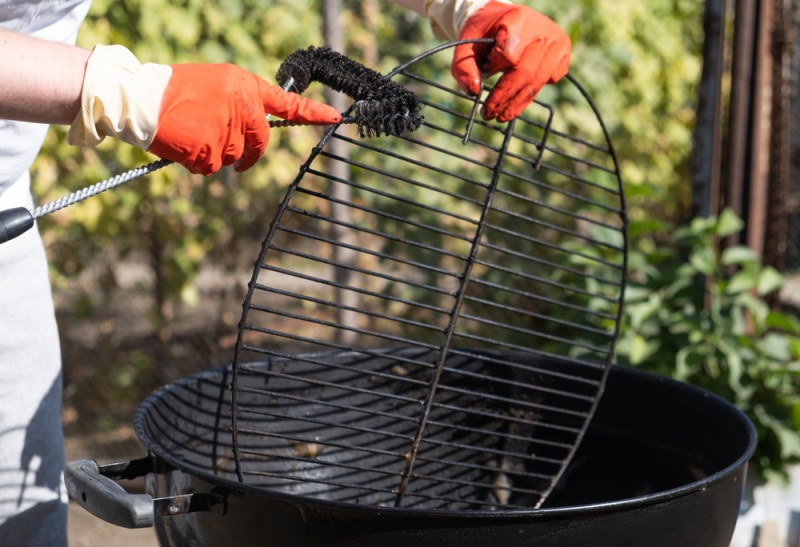 man using BBQ gloves