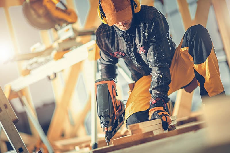 Construction Worker in His 40s with Nail Gun in His Hand