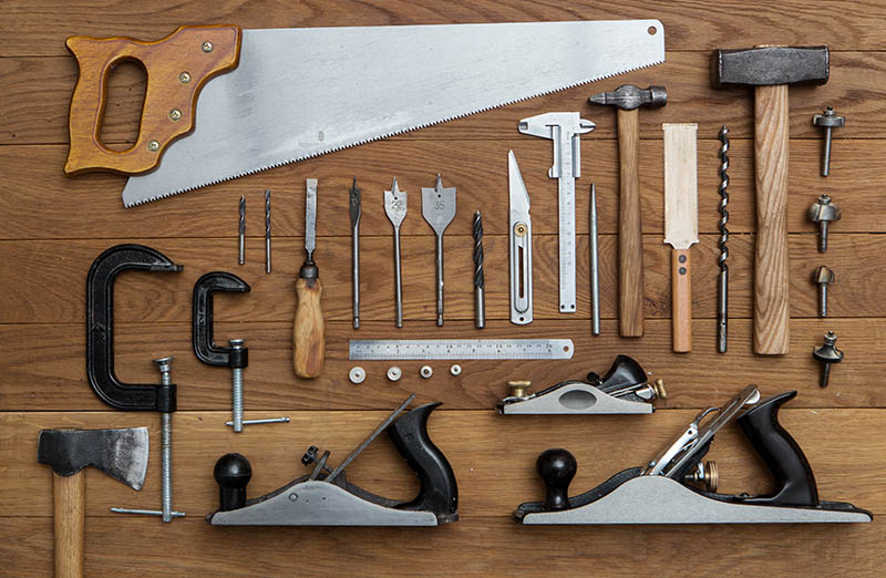 Tools for carpenter on wood background