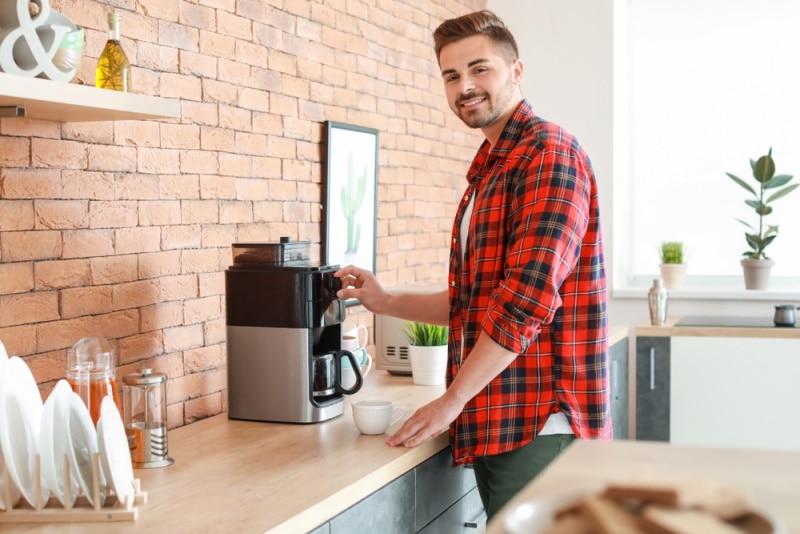 man using coffee maker