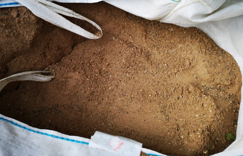 open bag of builders sand for construction and landscape projects