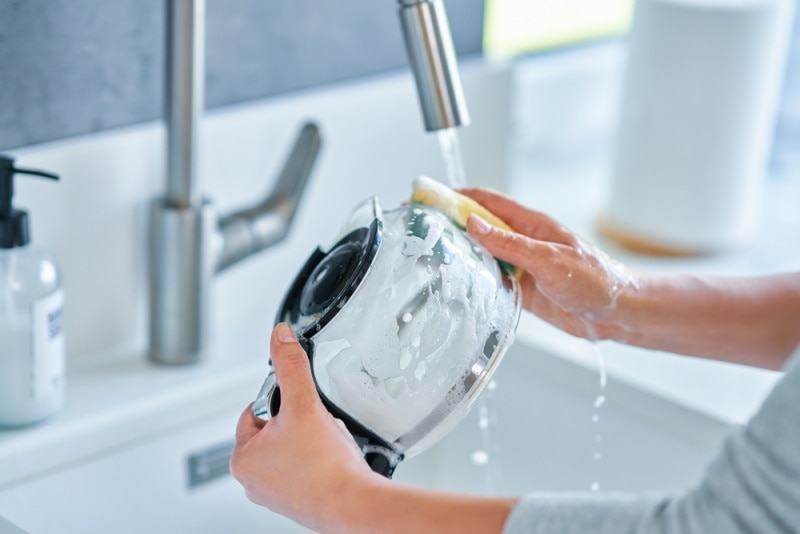 woman cleaning coffee pot
