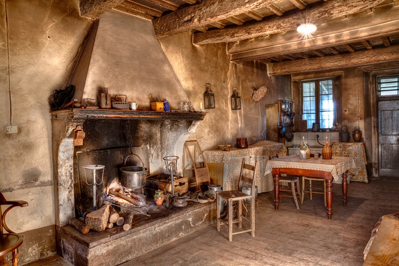 farmhouse - interior of an old country house with fireplace and kitchen