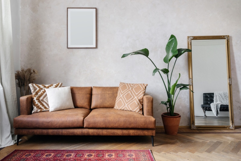 Modern design of living room with brown eco leather couch