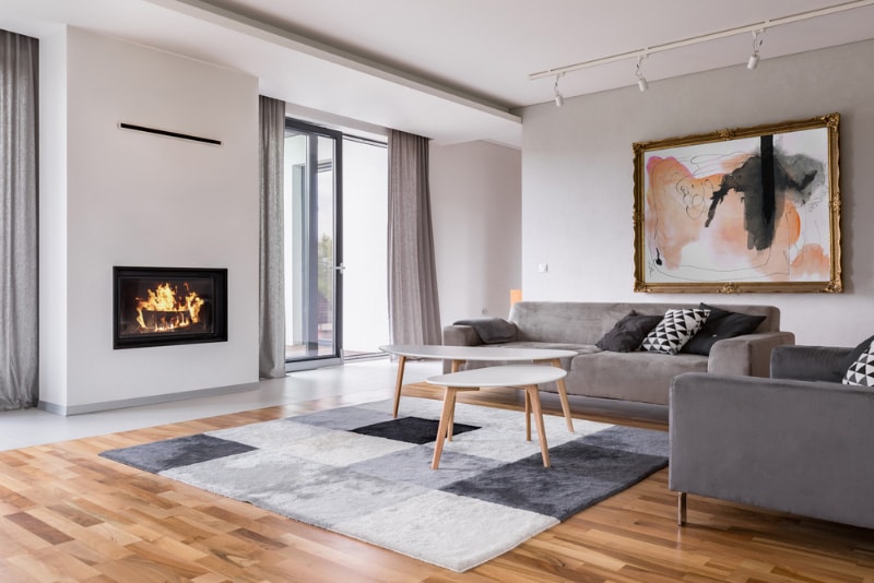 Modern living room with fireplace, sofa, balcony and pattern carpet