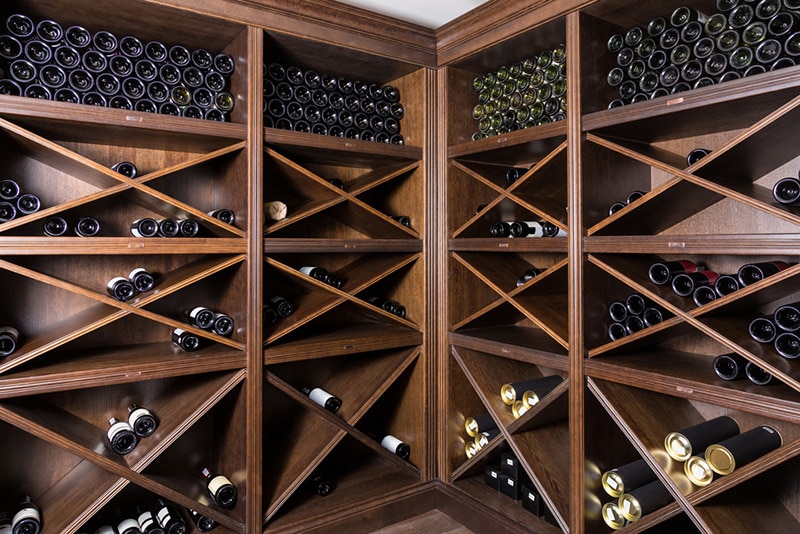 Wine cellar with bottles on wooden shelves