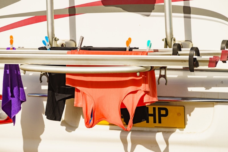 camper rv with clothes hanging to dry on back rack