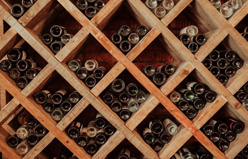dark wooden storage or wine rack with empty bottles