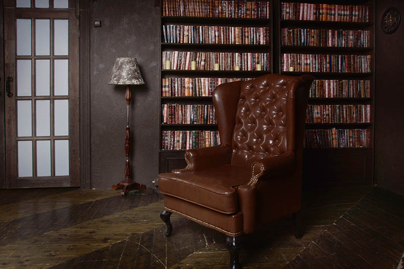 Classical library room with leather armchair