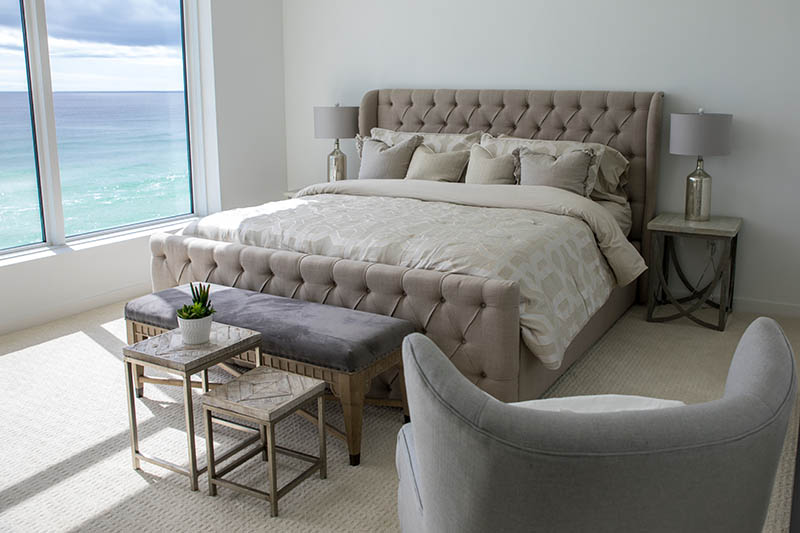 Neutral colored bedroom with beach view